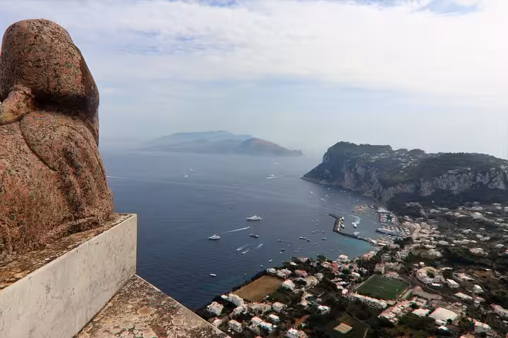 Stunning view from Anacapri featuring a statue overlooking the scenic coastline and azure waters.
