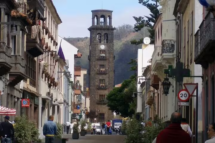 Stroll through a charming historic street leading to the iconic clock tower in Tenerife's Anaga region.