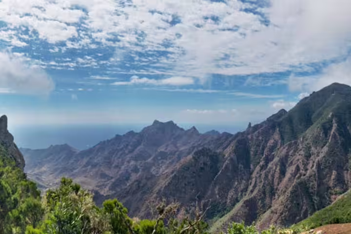 Panoramic view of rugged Anaga Tenerife mountains under a vibrant sky, showcasing natural beauty and adventure.