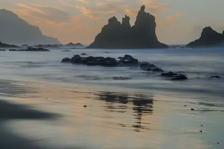 Dramatic coastal view of Anaga's rocky formations at sunset, showcasing Tenerife's natural allure on a half-day tour.
