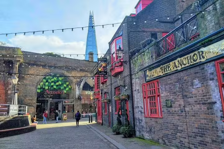 The Anchor pub on Bankside Southwark with The Shard skyscraper visible behind historic brick buildings