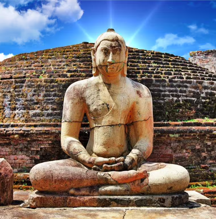 Majestic ancient Buddha statue under a bright sky in Polonnaruwa, symbolizing Sri Lanka's rich Buddhist history and spirituality.