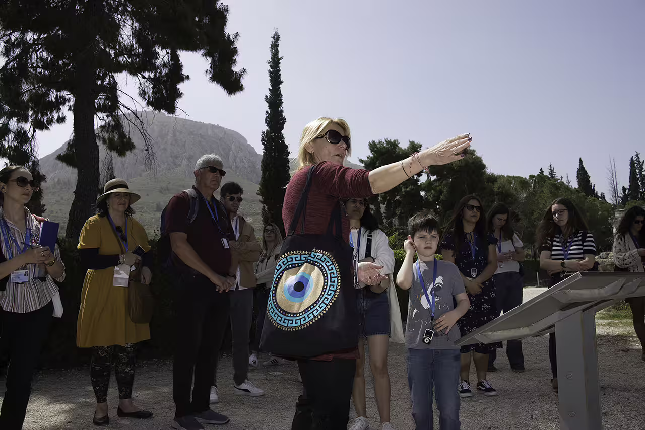 Guide briefing group at Ancient Corinth archaeological site, part of full-day Corinth and Nafplion guided tour