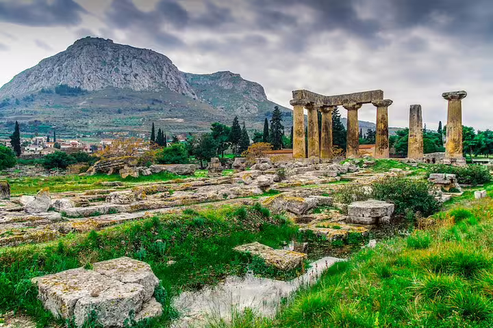 Ancient Corinth Temple of Apollo ruins with Acrocorinth hill, stop on Athens highlights private day tour