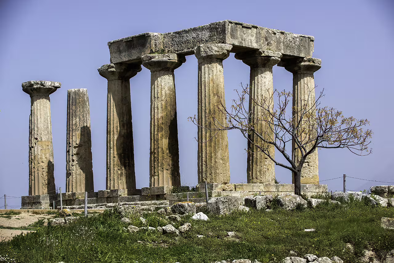 Ancient Corinth Temple of Apollo columns on a guided full-day tour from Athens to the Peloponnese
