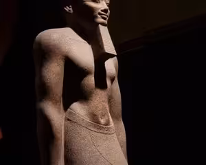 Ancient Egyptian stone statue at the Grand Egyptian Museum, Cairo