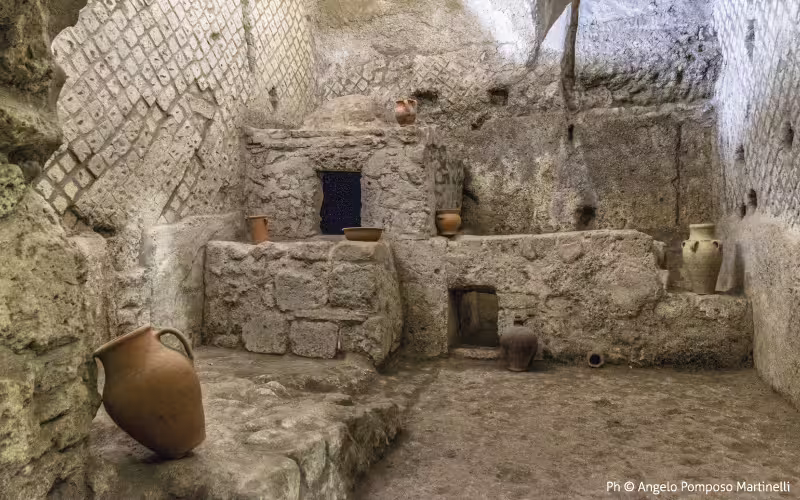 Subterranean chamber with stone altar and ancient amphorae on the Ancient Naples Buried Path archaeological tour