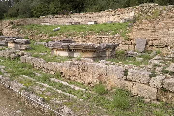 Ancient Olympia ruins with stone foundations and altar remains on a full-day private tour in Peloponnese Greece