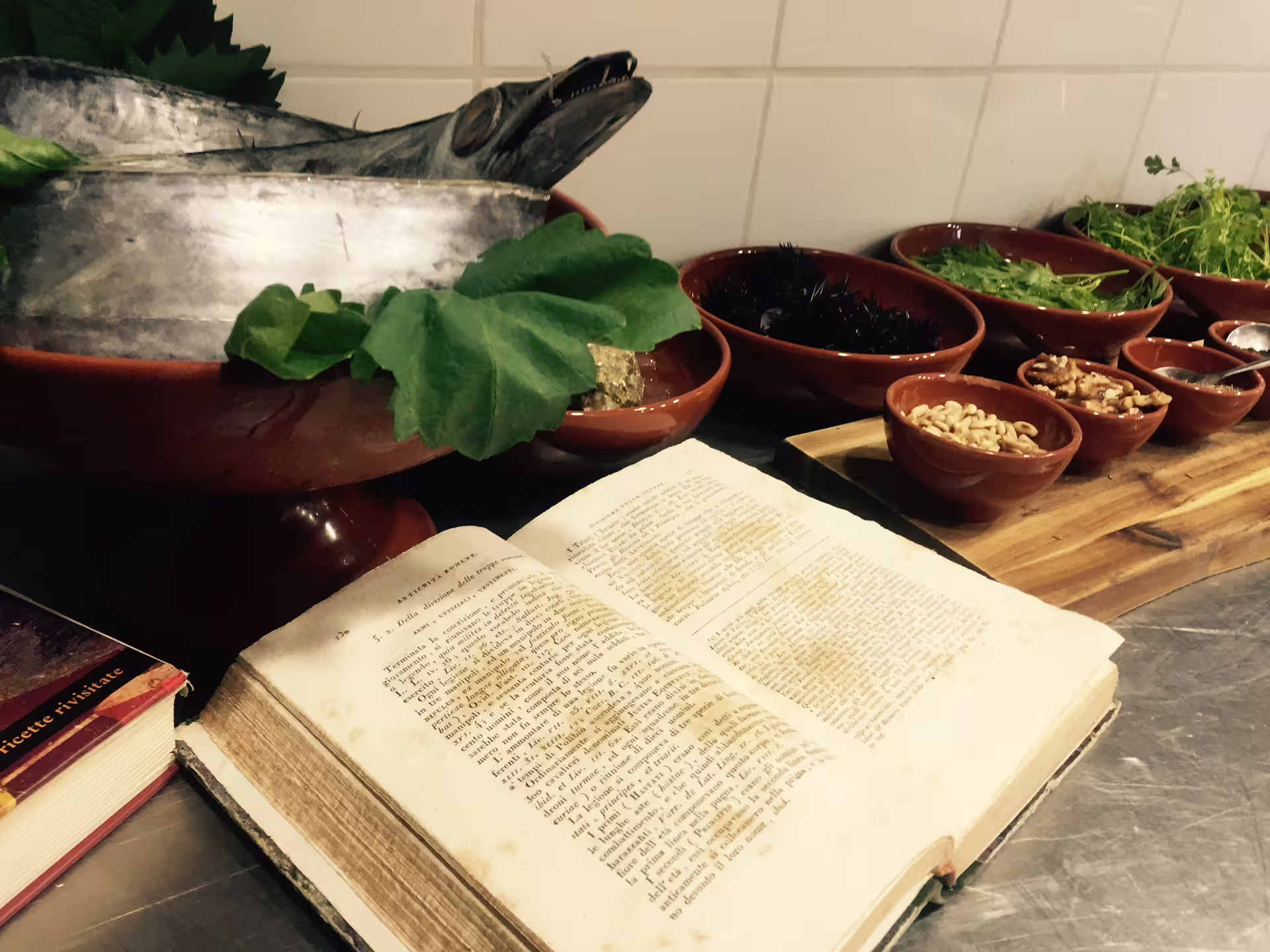 Ancient Roman cookbook with fresh seafood, herbs and ingredients prepared for authentic Pompeii lunch experience