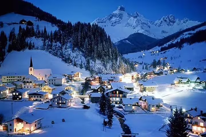 Enchanting night view of a snow-covered Andorran village nestled in the Pyrenees, perfect for winter tours.