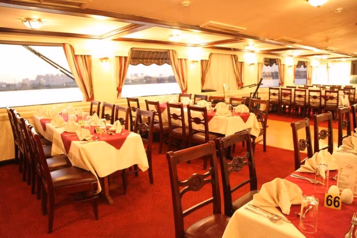 Elegant dining salon on Andrea Nile cruise with set tables and river views, ideal Memphis cruise transfer tour