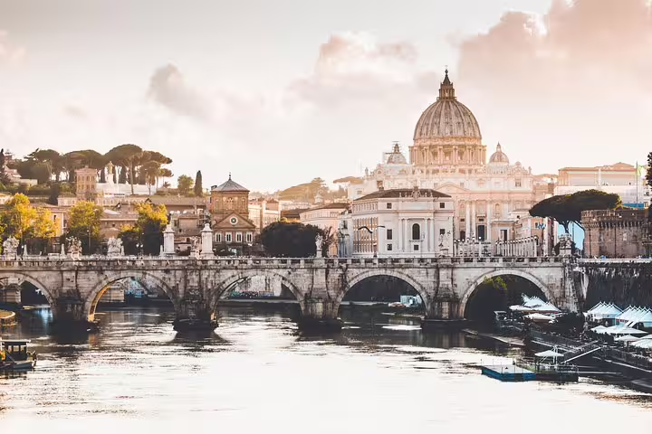 St. Peter's Basilica dome and Ponte Sant'Angelo bridge over the Tiber River in Rome