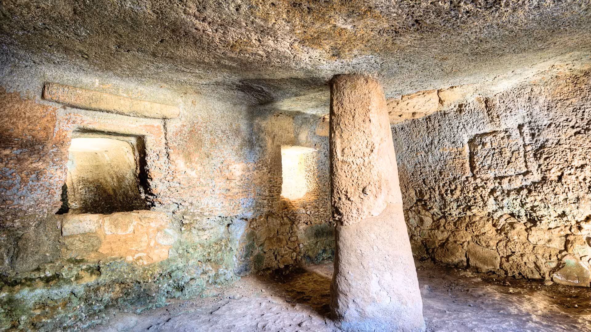 Explore the ancient tombs of Anghelu Ruju Necropolis in Alghero, nestled in lush greenery with guided audio tours.