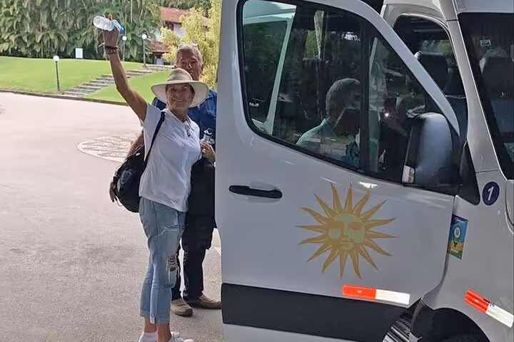 Traveler boards a shuttle for the Angra dos Reis to Paraty shared transfer service, featuring comfortable travel.