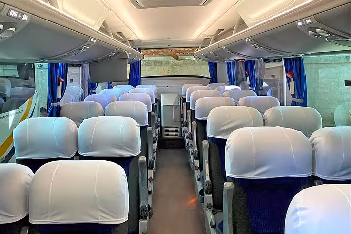 Spacious and comfortable seating inside a coach bus, ideal for the shared shuttle journey from Angra dos Reis to Paraty.