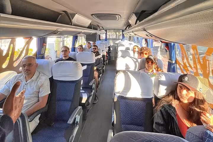 Passengers enjoying a comfortable bus ride from Angra dos Reis to Rio de Janeiro with ample seating and sunlight.