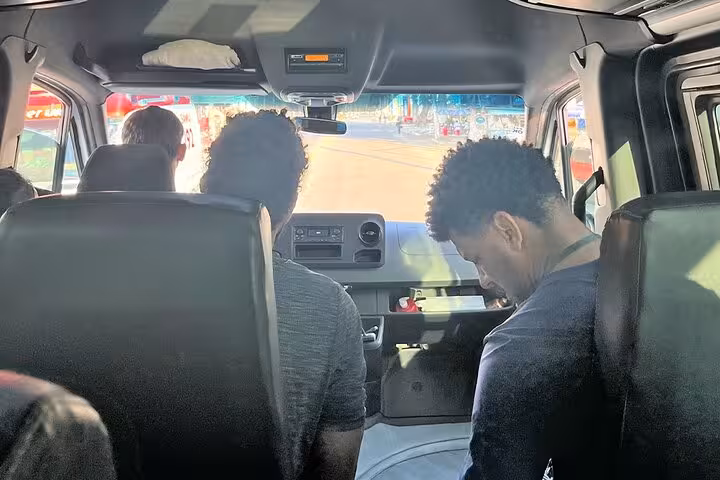 Passengers seated inside a shared transfer van en route from Angra dos Reis to Rio de Janeiro, showcasing interior comfort.