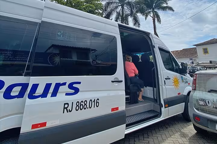 Tourists boarding a shared transfer van in Angra dos Reis, ready for a scenic journey to Rio de Janeiro.