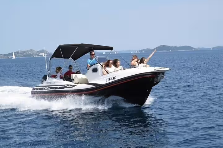 Group enjoying a thrilling ride on a private speedboat during an Angra & Ilha Grande tour under a clear sky.