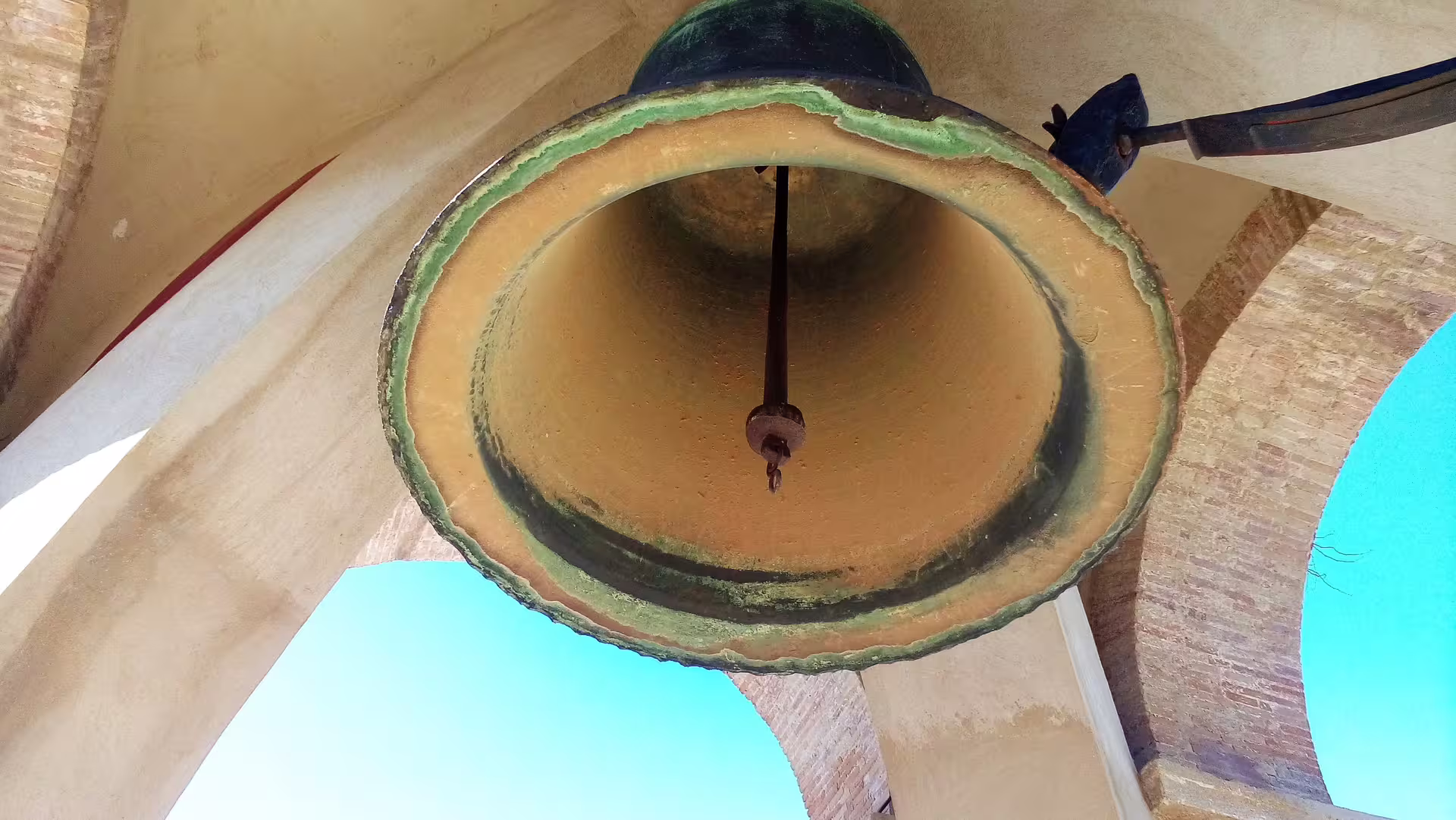 Close-up of historic bell inside Antequera Alcazaba, a highlight on a private full-day trip from Costa del Sol