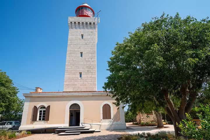 Historic lighthouse with red lantern room and keeper's house in Antibes, French Riviera