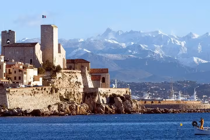 Historic Antibes old town fortress on the French Riviera with snow-capped Alps in the background
