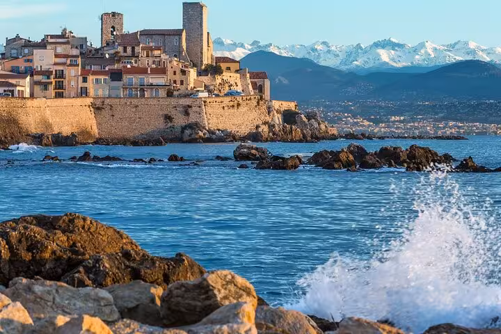 Antibes old town ramparts overlooking the Mediterranean Sea with snow-capped Alps in background, French Riviera