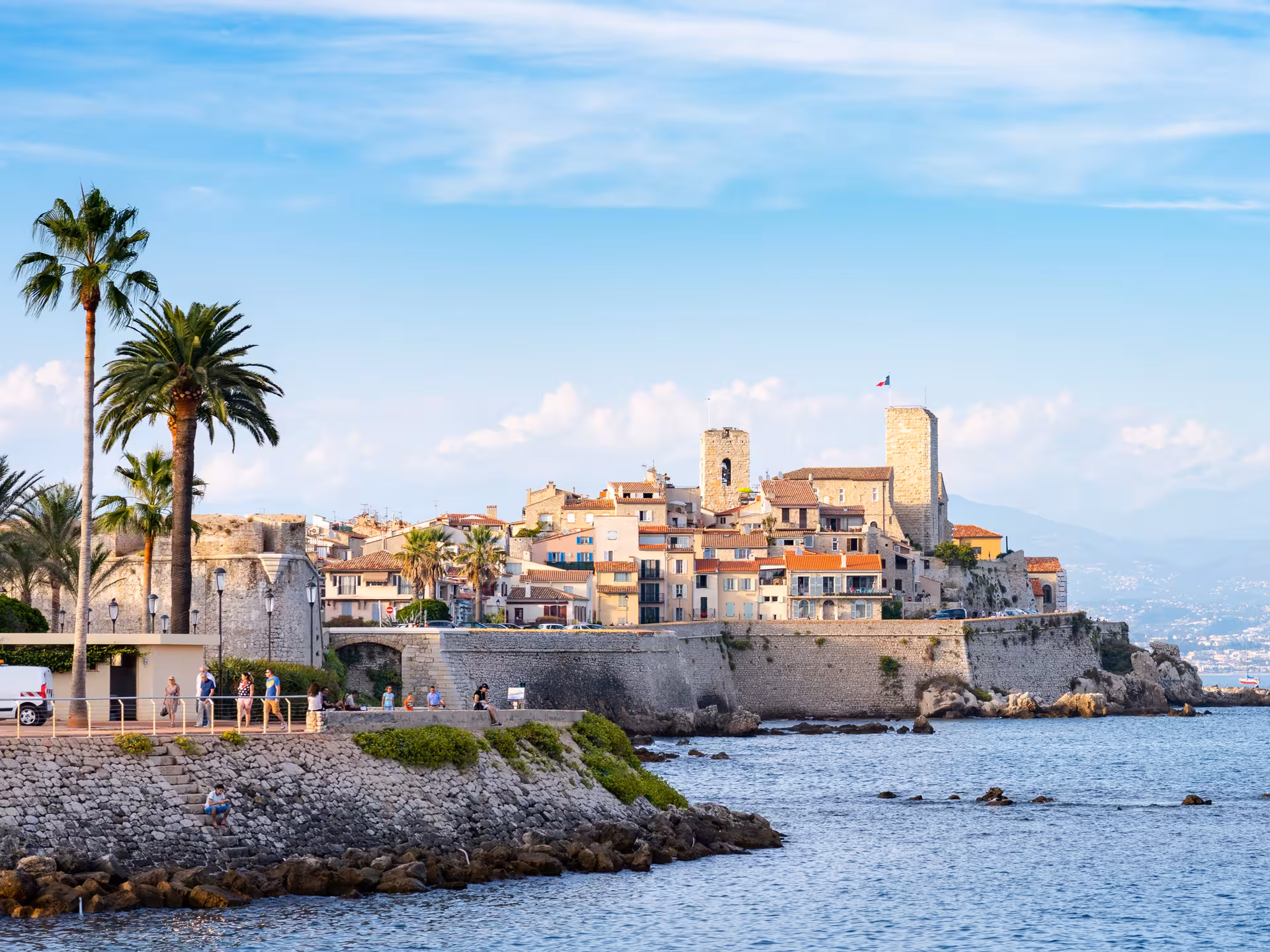 Historic old town of Antibes with medieval ramparts, palm trees, and Mediterranean sea on the French Riviera