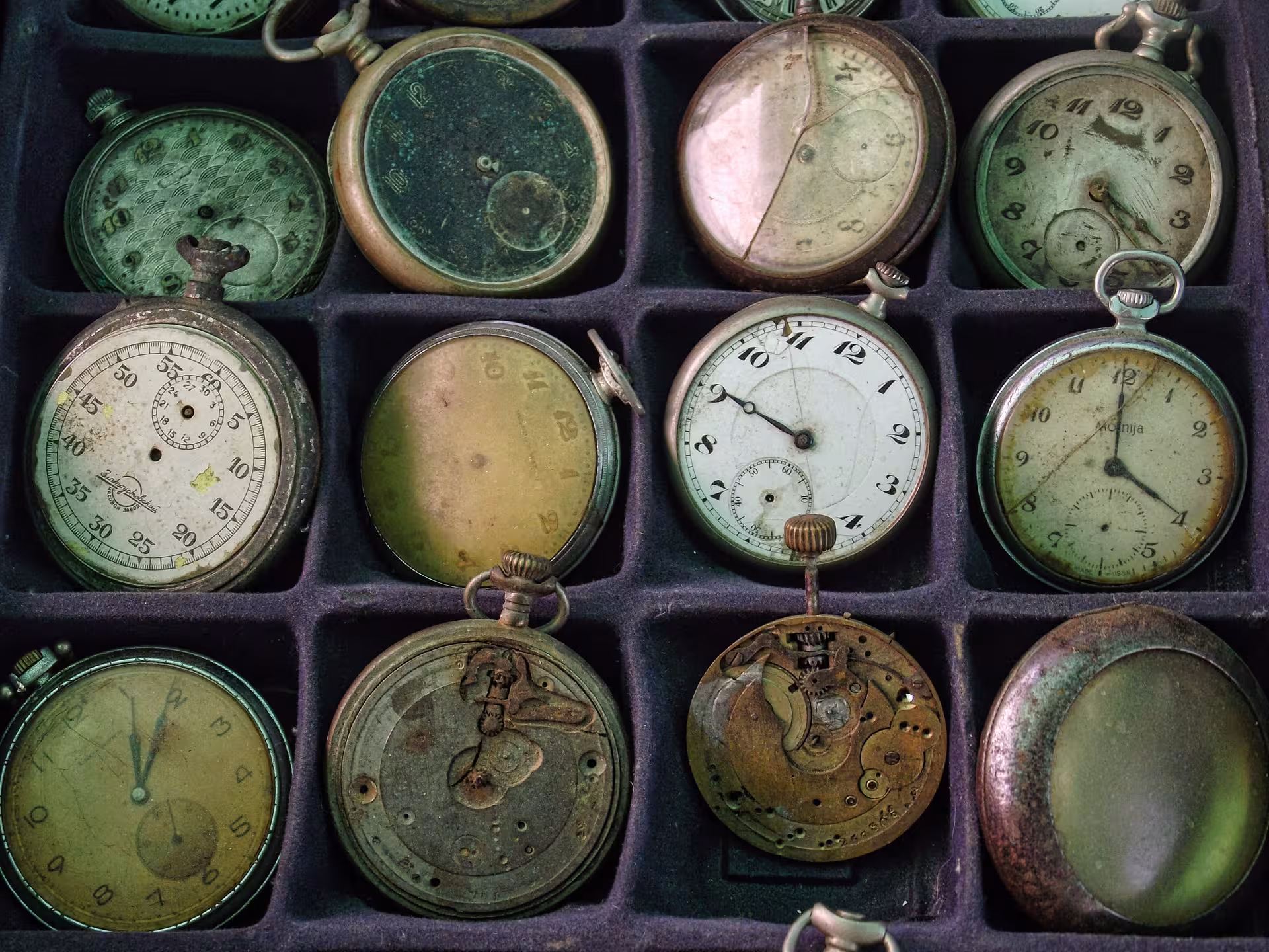 Collection of aged antique pocket watches with patina displayed at Negreni Flea Market guided antiques tour