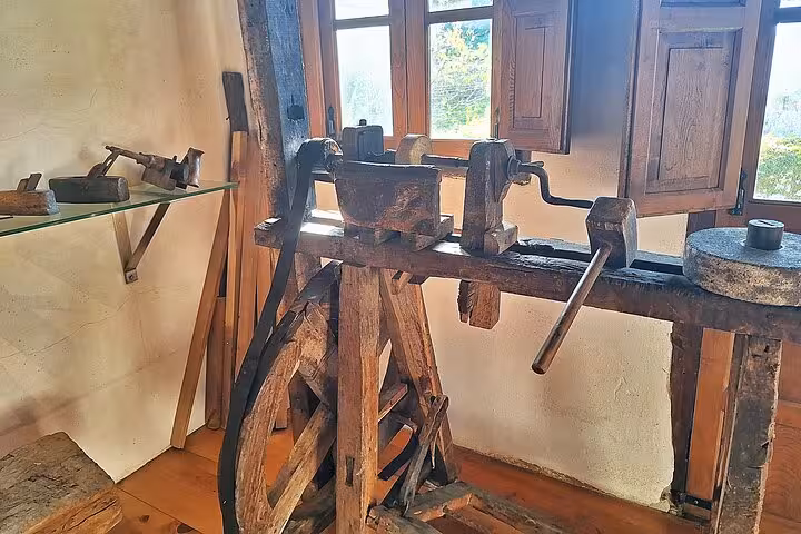 Antique woodworking tool display in the Ethnographic Museum of Eastern Asturias, showcasing local craftsmanship.