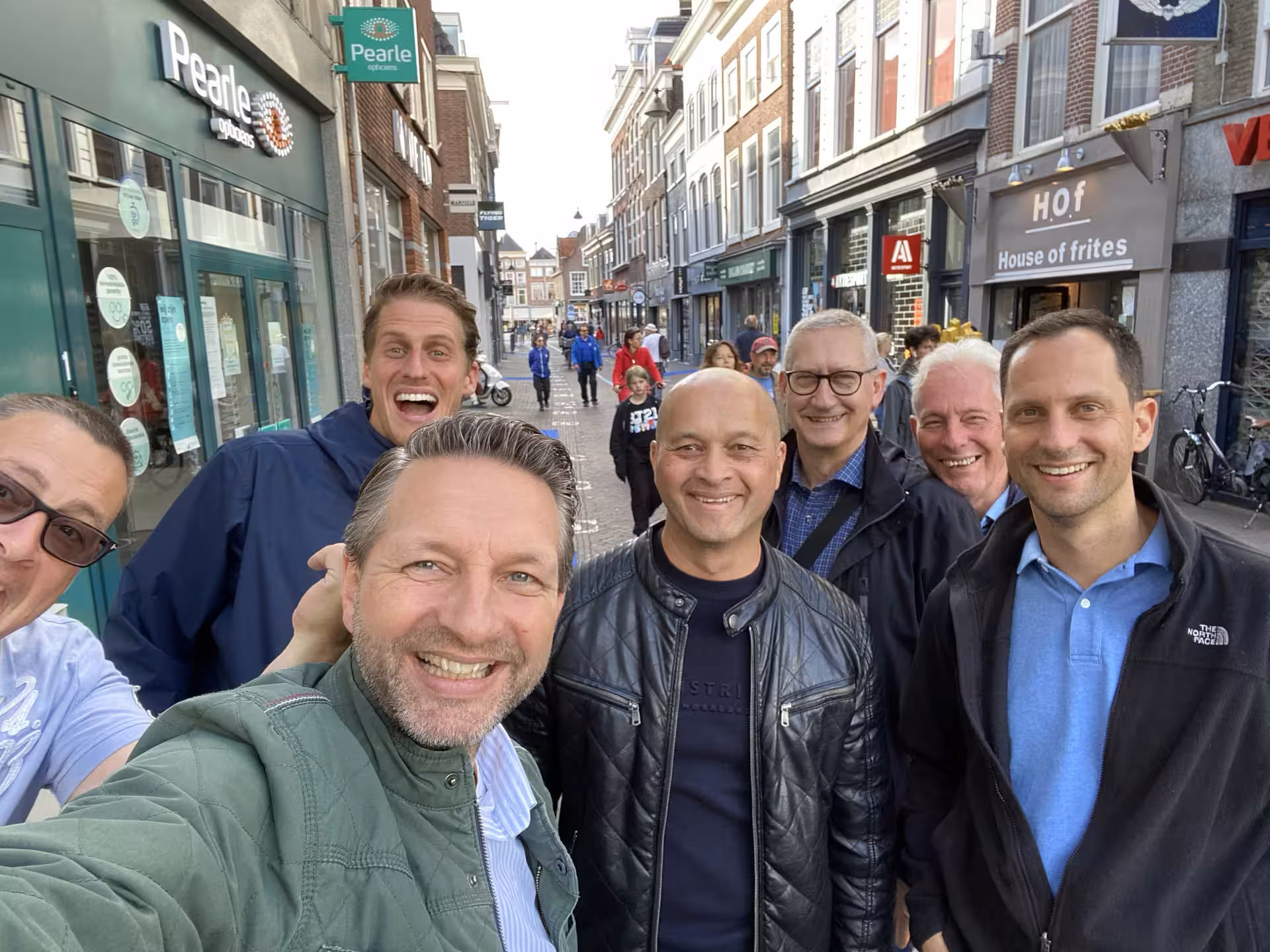 Group selfie on a shopping street during the Antwerp e-scavenger hunt, app-based self-guided city walk tour