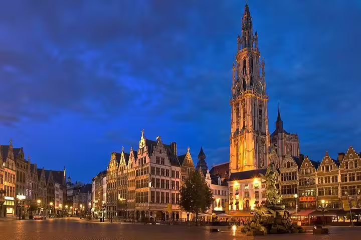 Antwerp Grote Markt at dusk with Cathedral of Our Lady lit up, highlight of a private guided history tour