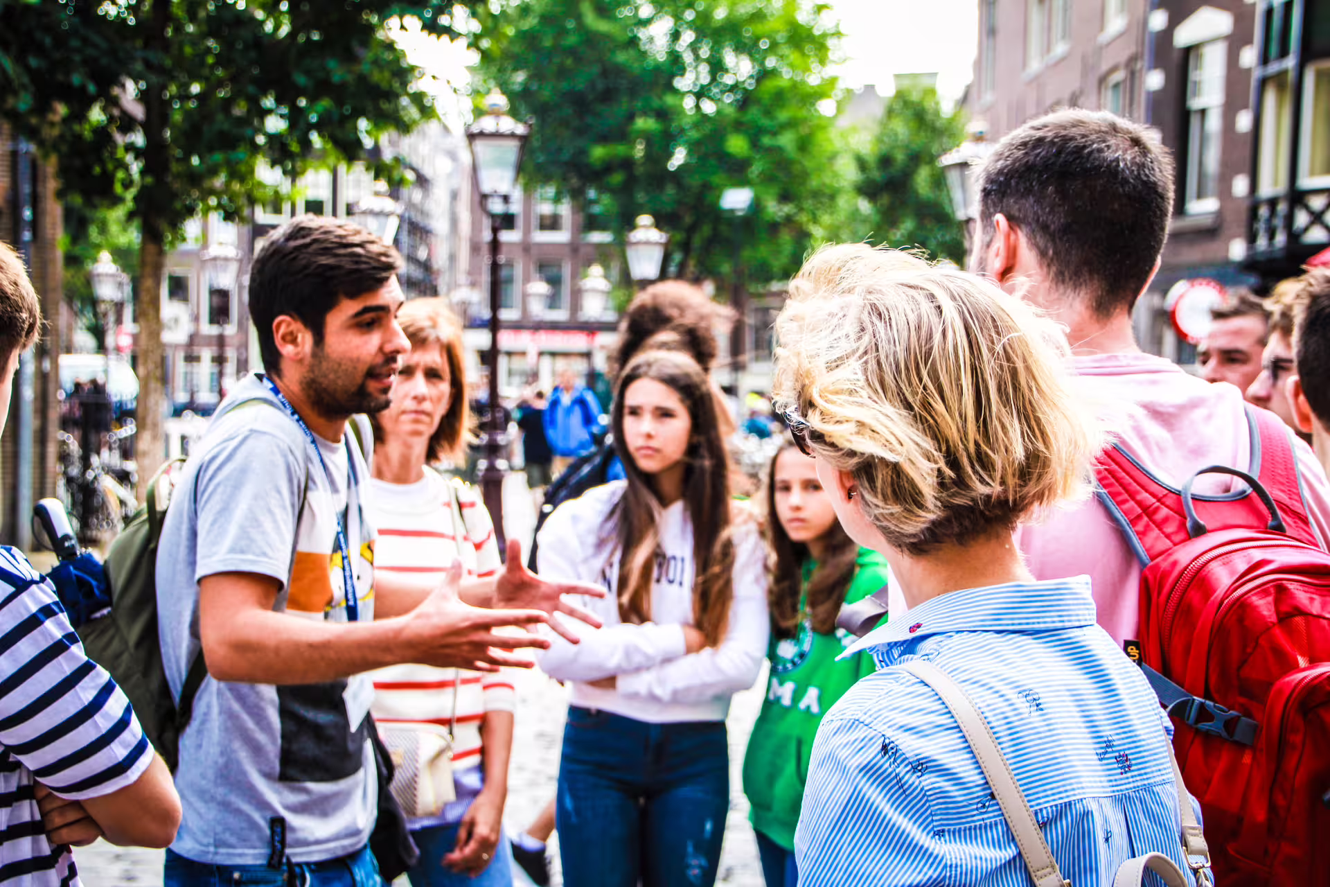 A passionate guide leads a group on an Antwerp private walking tour, exploring the vibrant streets of Belgium's diamond district.