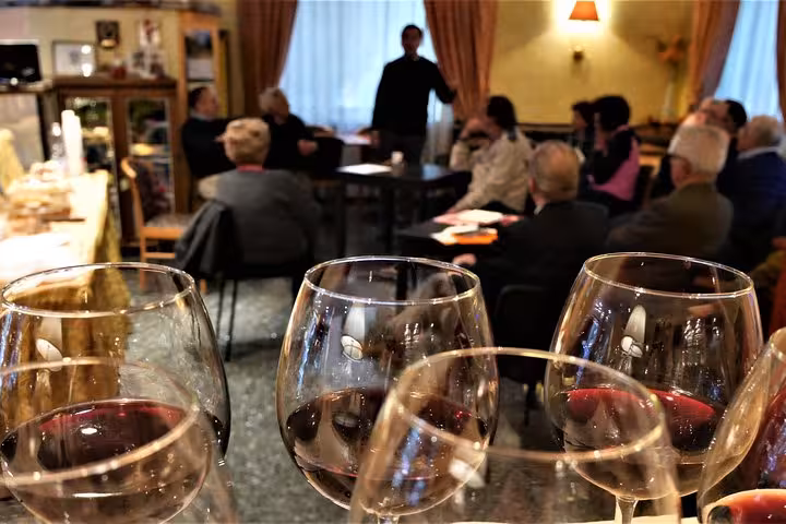 Group enjoying an Aperitivo with Monte Cassino history discussion and Gustav Wine tasting in a cozy setting.