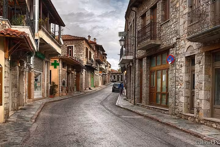 Charming stone-paved street in Arachova near Delphi, traditional houses and balconies on a luxury day trip