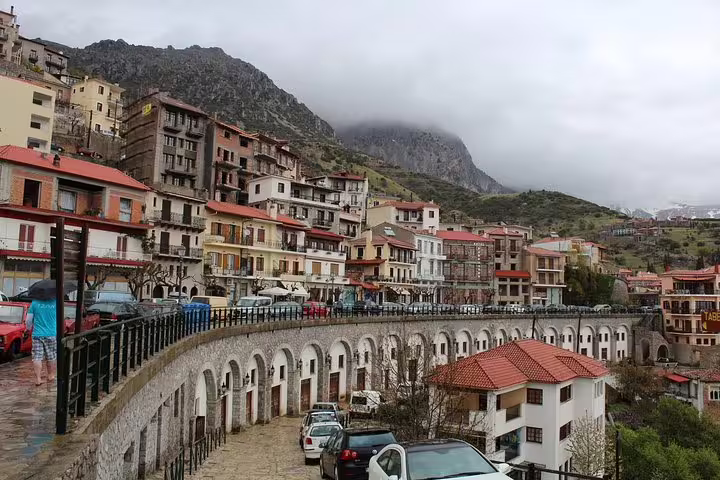Scenic view of Arachova village on a cloudy day, showcasing traditional architecture and mountainous landscape near Delphi, Greece.