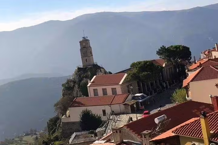 Arachova village rooftops and clock tower with mountain views, stop on Delphi Arachova Distomo day trip