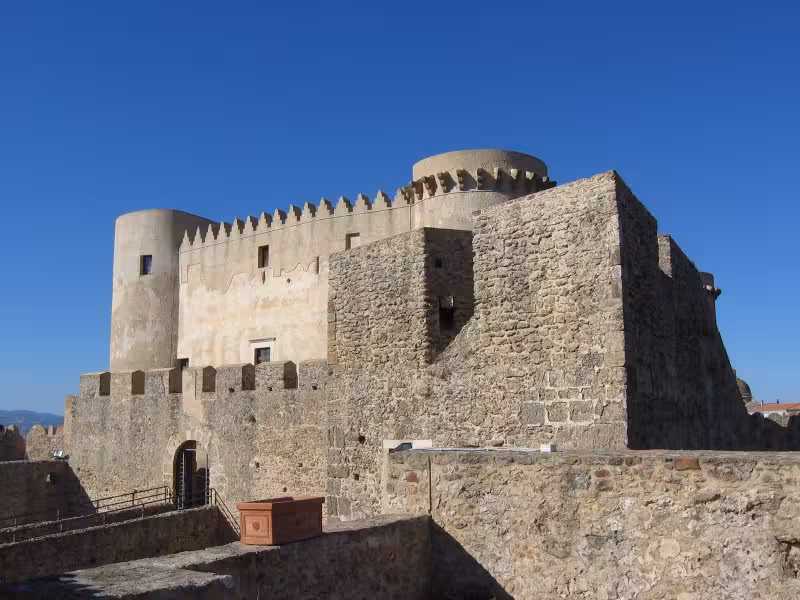 Close-up of the medieval Aragonese castle in Crotone, Calabria, with stone ramparts and blue sky on a wine heritage tour