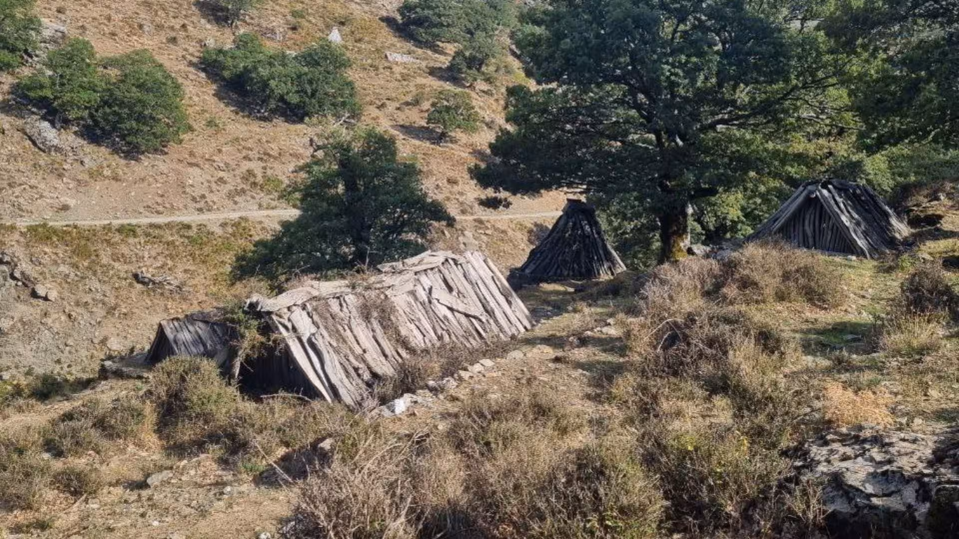 Traditional shepherd huts in the scenic Barbagia landscape during a jeep tour from Arbatax.