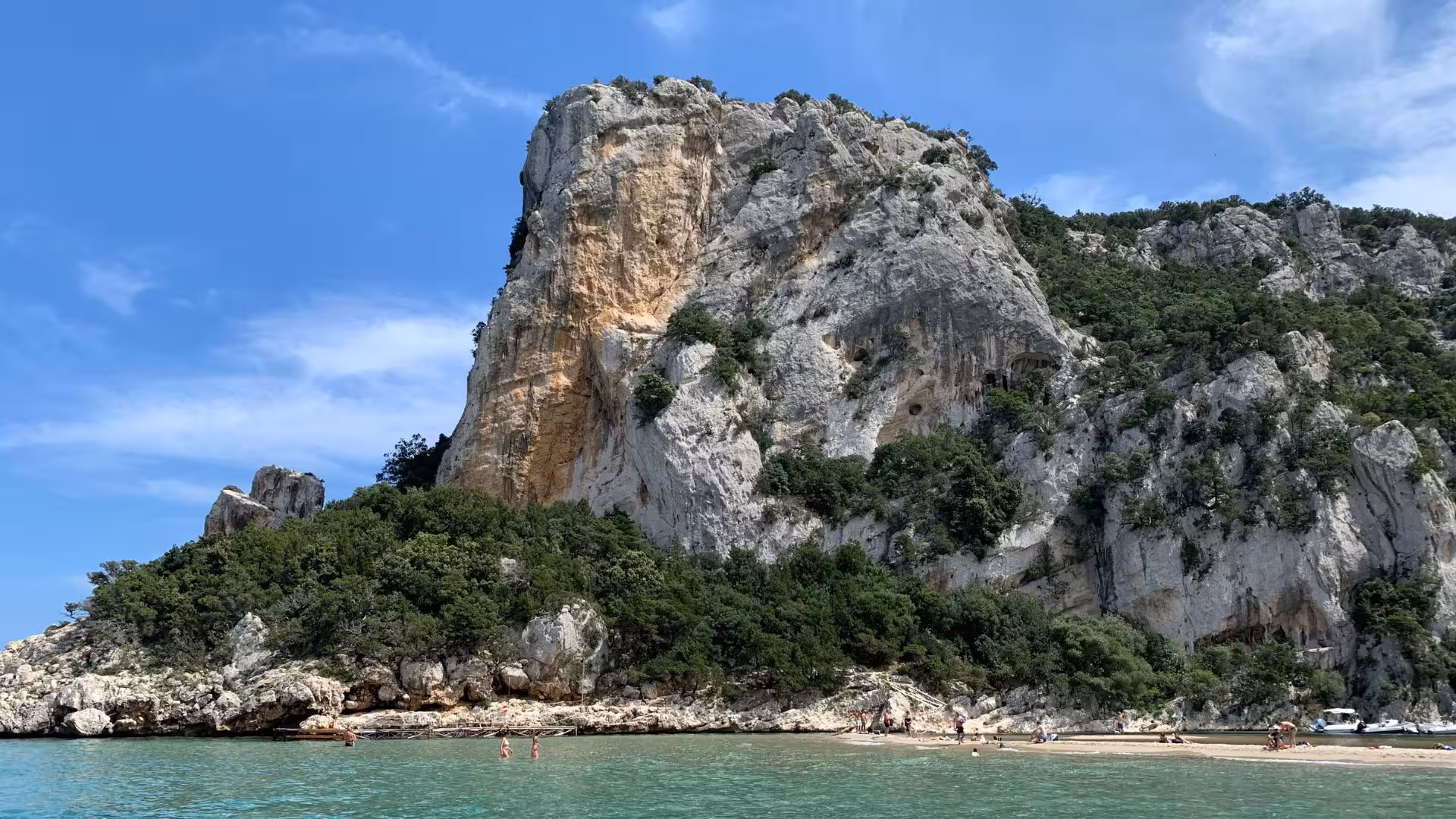 Majestic limestone cliffs and sandy beach at Cala Goloritzé, a highlight of the RIB tour from Arbatax.