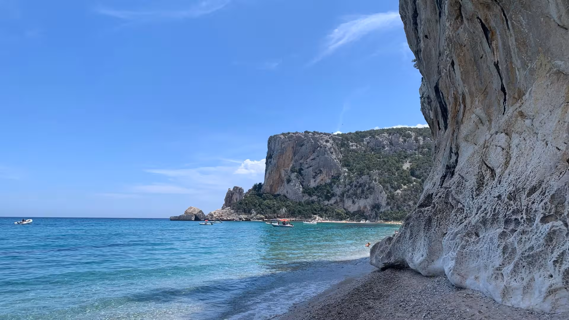 Stunning view of Cala Luna's turquoise waters and rocky cliffs on a sunny day, ideal for a RIB trip from Arbatax.
