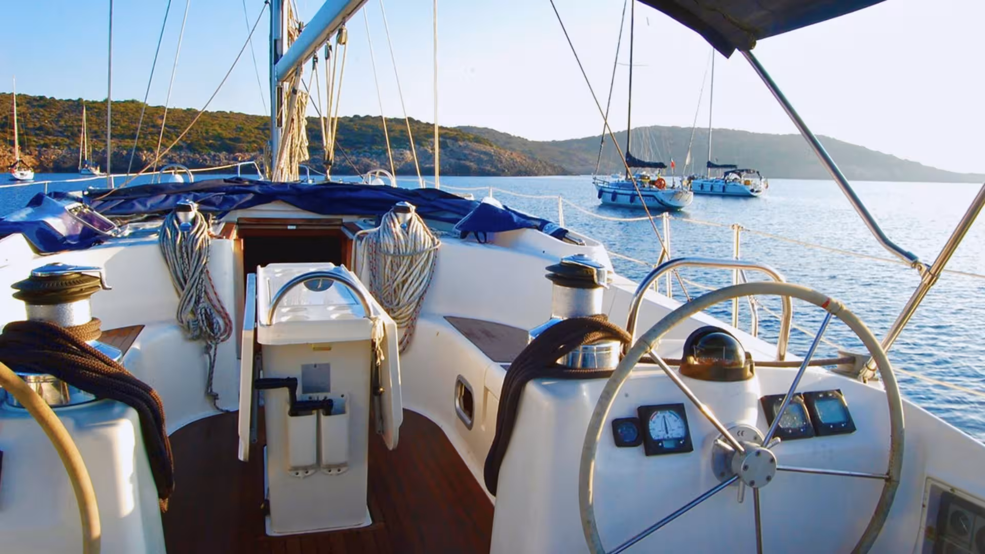Helm of a sailboat overlooking the serene Gulf of Orosei, perfect for sailing adventures from Arbatax.