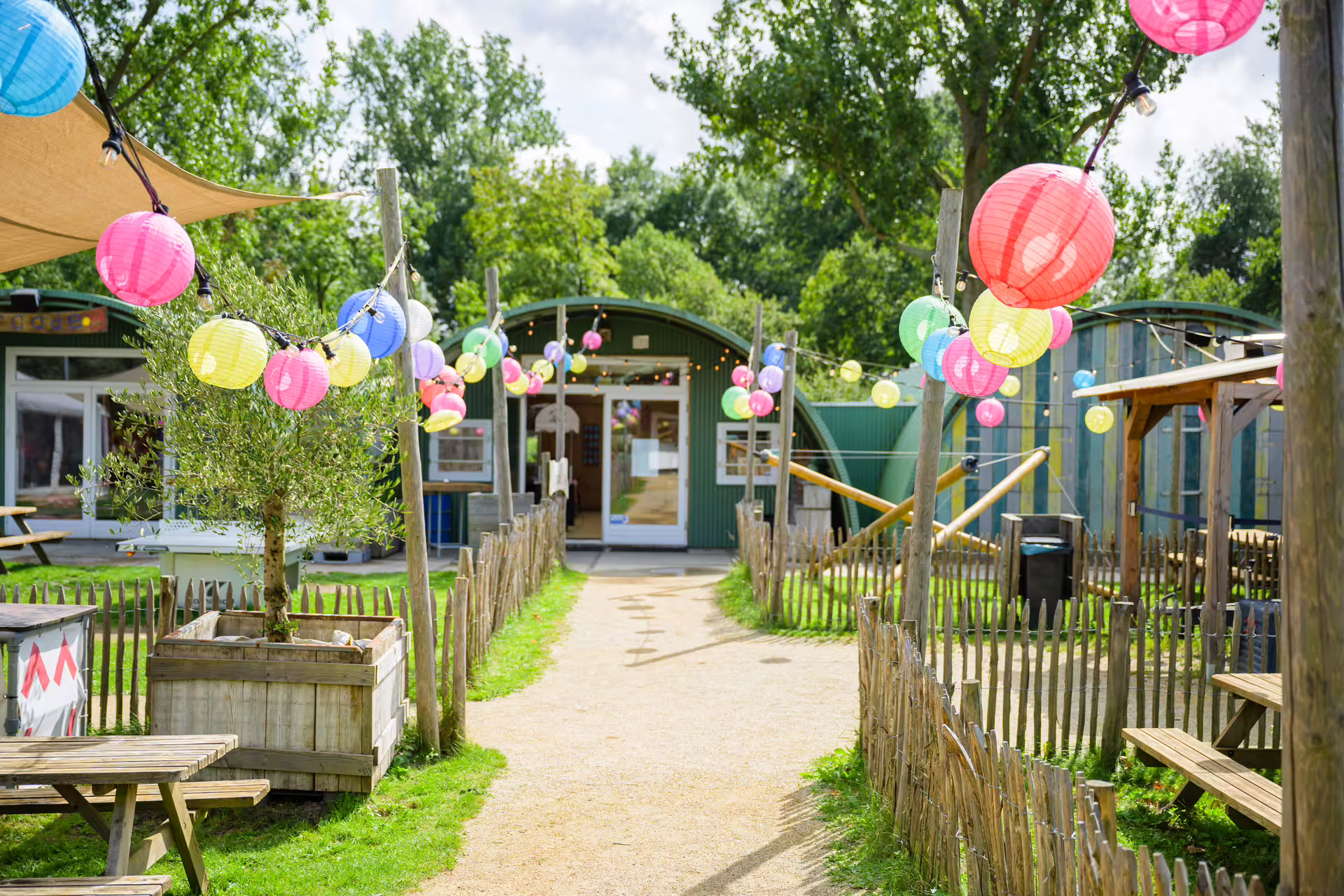 Outdoor archery range in Amsterdam with colorful lanterns and picnic benches at the shooting venue