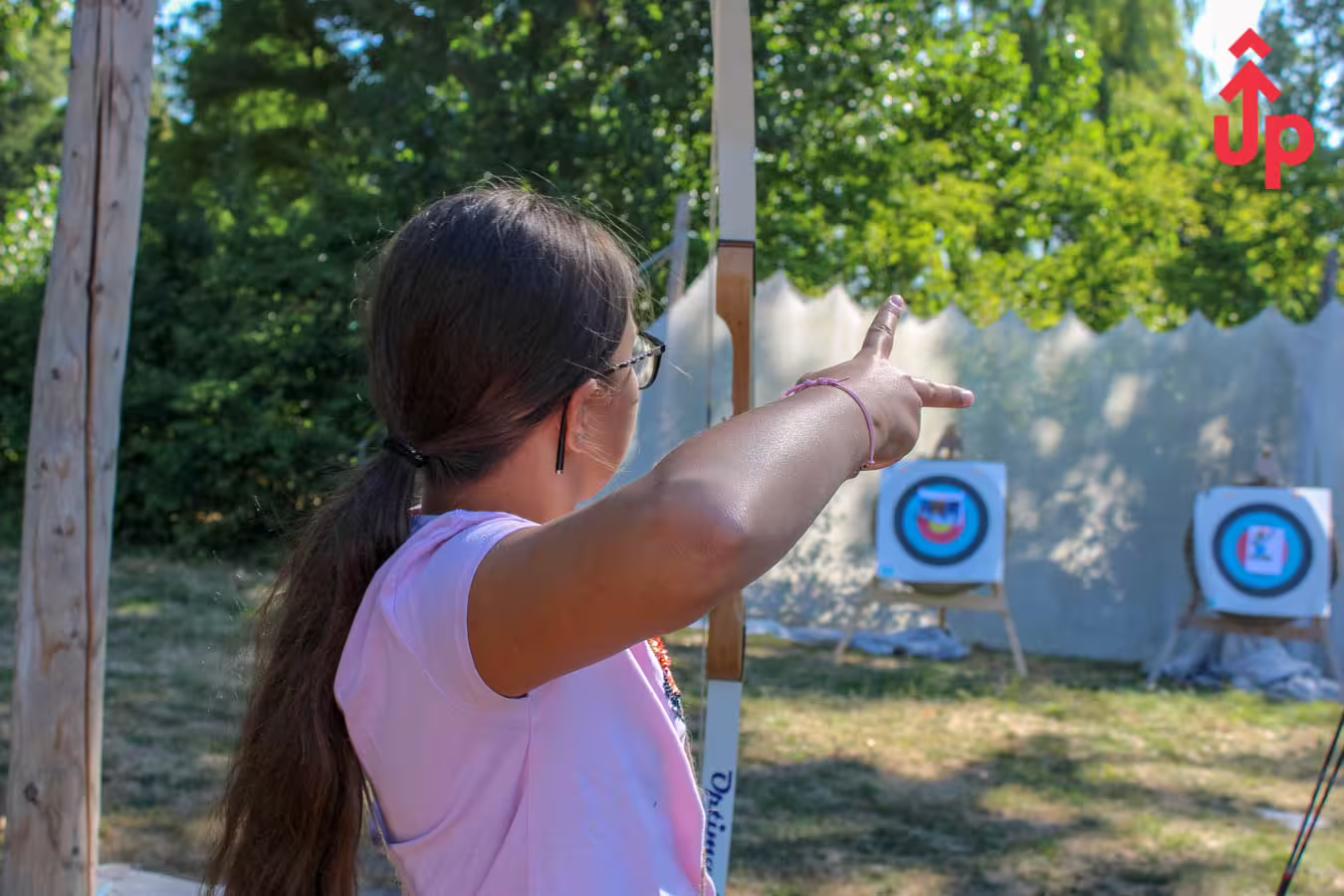 Instructor guiding a beginner at the archery range in Amsterdam, pointing toward targets during lesson