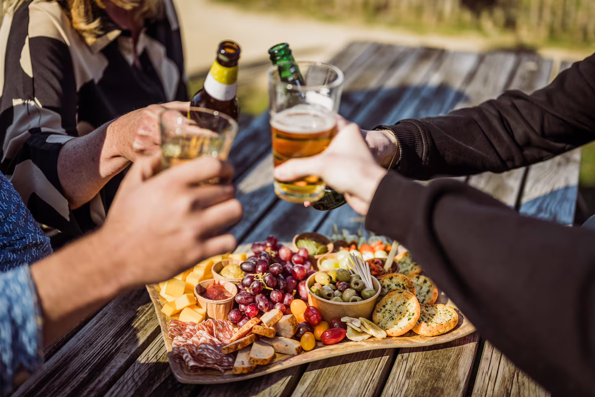 Post-archery picnic in Weesp with drinks and shared charcuterie board, ideal for group outings near Amsterdam