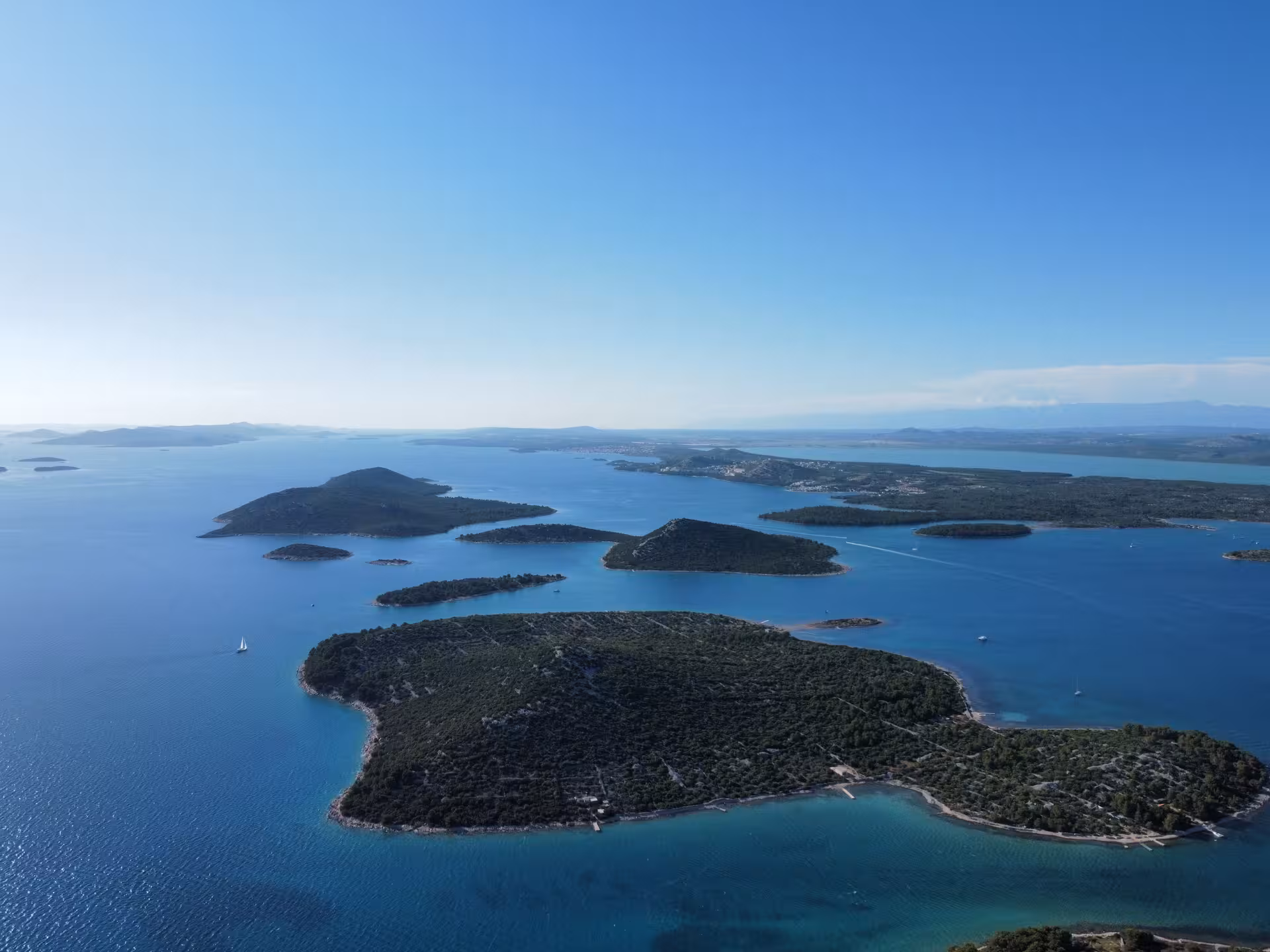 Panoramic aerial of scattered Adriatic islands and calm blue water, ideal for Archipelago Adventure cruise tour