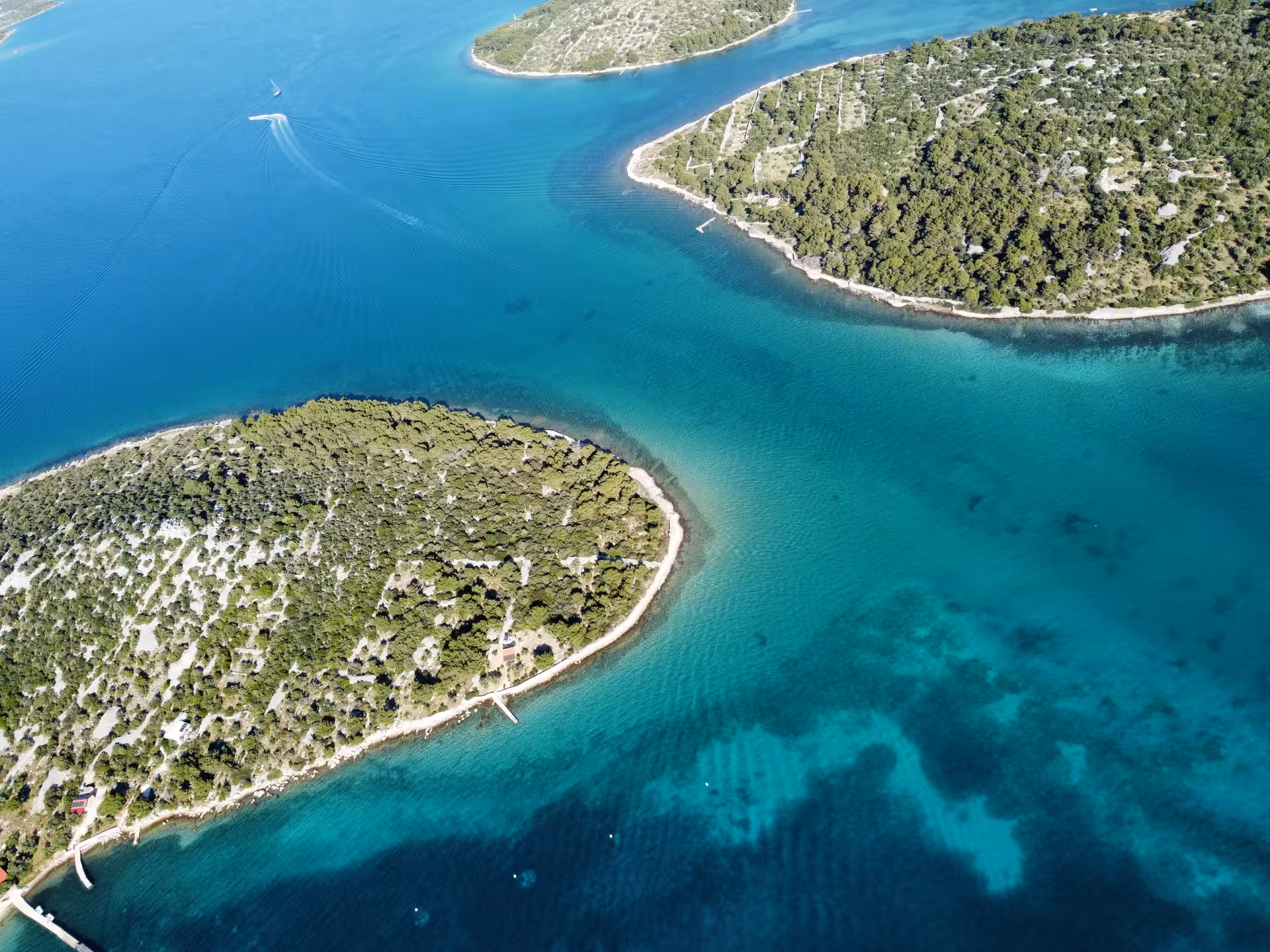 Drone view of turquoise bays and pine-covered islets, perfect for Archipelago Adventure sailing and snorkeling