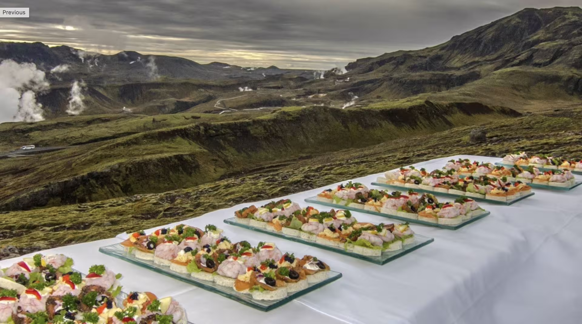 Arctic Table outdoor feast featuring fresh Icelandic canapes displayed against dramatic geothermal mountain landscape