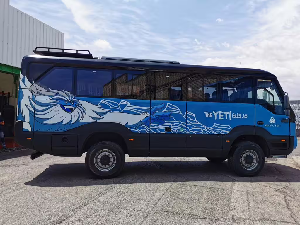 Blue Arctic Yeti bus with yeti artwork wrap for Landmannalaugar transfers from Reykjavik