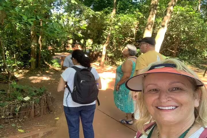 Visitors exploring a shaded forest trail during the Argentine and Brazil Falls Full-day Private Tour.